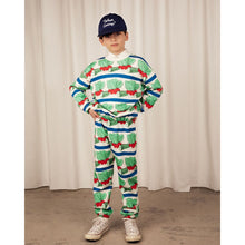Load image into Gallery viewer, Mini Rodini - White sweatpants with blue stripe and all over veggie print
