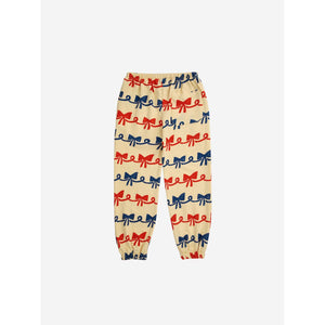 Bobo Choses - beige sweatpants with all over ribbon bow print in red and blue