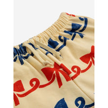 Load image into Gallery viewer, Bobo Choses - beige sweatpants with all over ribbon bow print in red and blue
