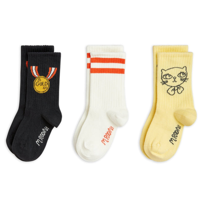 Mini Rodini - 3 pack socks. Black with medal motif, white with red stripe and yellow with cat print
