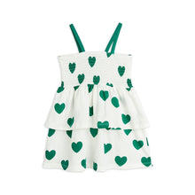 Load image into Gallery viewer, Mini Rodini - white smock dress with green straps and green heart print
