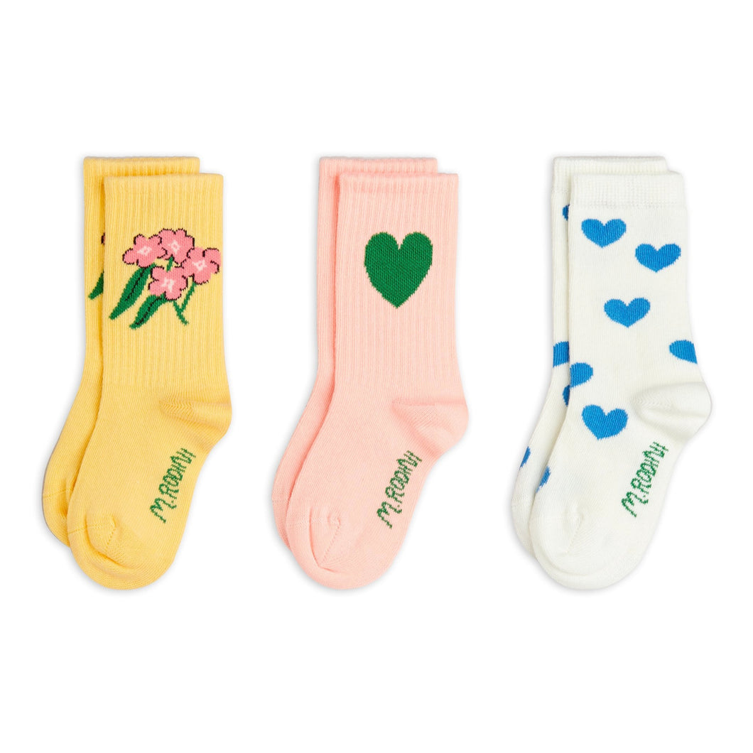 Mini Rodini Three pairs of socks with floral, heart, and blue heart designs 
