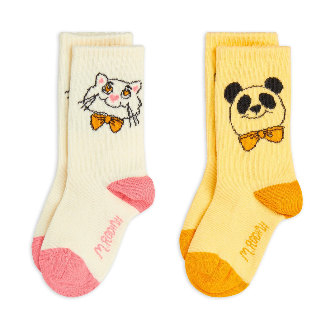 Mini Rodini twin pack of socks, one white pair with cat motif and ne yellow pair with panda motif