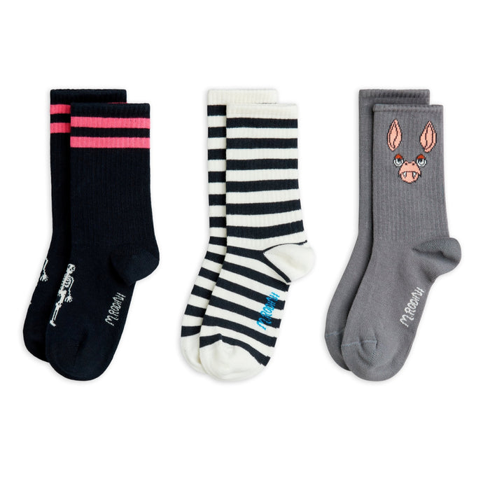 Three pairs of socks with different designs on a white background