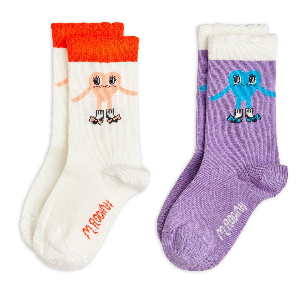 Two pairs of socks with cartoon characters on a white background
