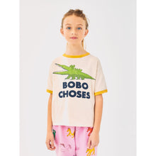 Load image into Gallery viewer, Bobo Choses off white t-shirt with yellow trim and green crocodile print from the new AW24 collection &#39;Once Upon A Time&#39;
