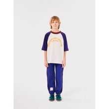 Load image into Gallery viewer, Bobo Choses off white t-shirt with yellow &#39;Once Upon a Time&#39; logo, indigo raglan sleeves and burgundy neck from the new AW24 collection &#39;Once Upon A Time&#39;
