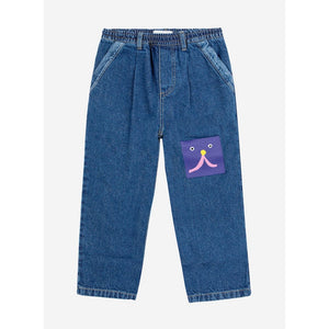 Bobo Choses blue denim trousers with funny face patch&nbsp;from the new AW24 collection 'Once Upon A Time'