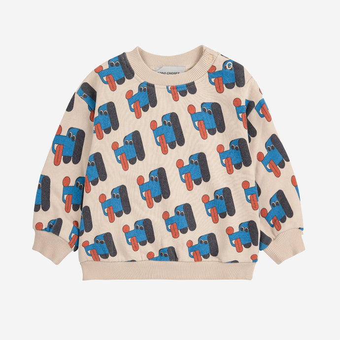 Bobo Choses baby sweater with blue dog pattern on a beige background