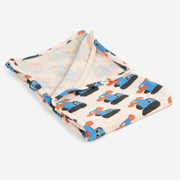 Bobo Choses muslin blanket with blue and orange dog patterns on a white background