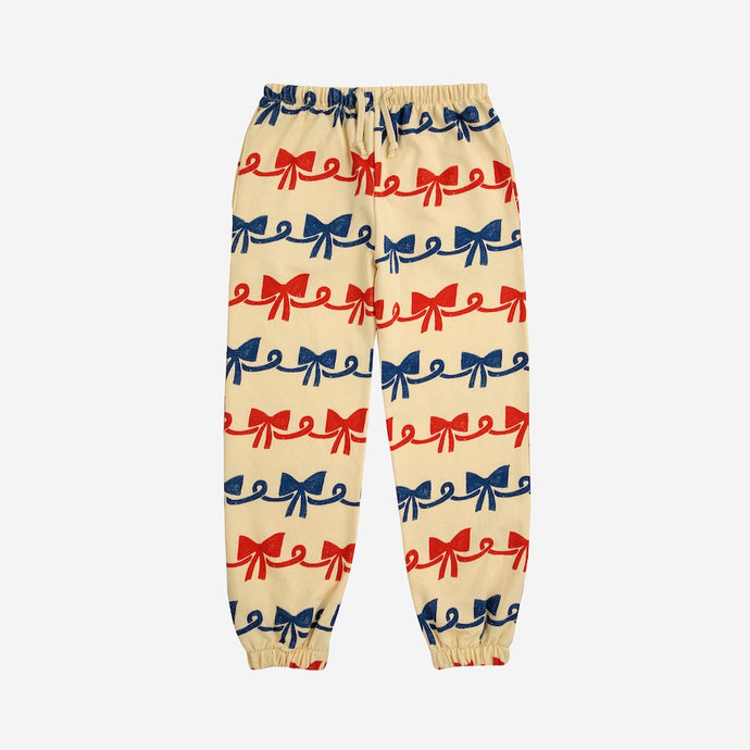 Bobo Choses - beige sweatpants with all over ribbon bow print in red and blue