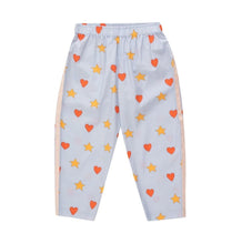 Load image into Gallery viewer, Tinycottons - pale blue trousers with all over red heart and yellow star print
