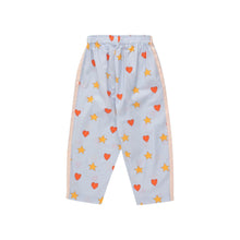 Load image into Gallery viewer, Tinycottons - pale blue trousers with all over red heart and yellow star print
