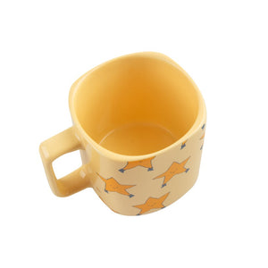 Tinycottons - pale yellow ceramic mug with all over dancing stars design in darker yellow