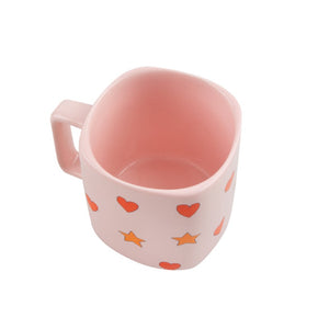 Tinycottons - pale pink ceramic mug with all over red heart and yellow star design