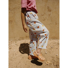 Load image into Gallery viewer,  Tinycottons - pale blue trousers with all over red heart and yellow star print
